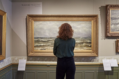 Woman looking at a painting in The Mesdag Collection
